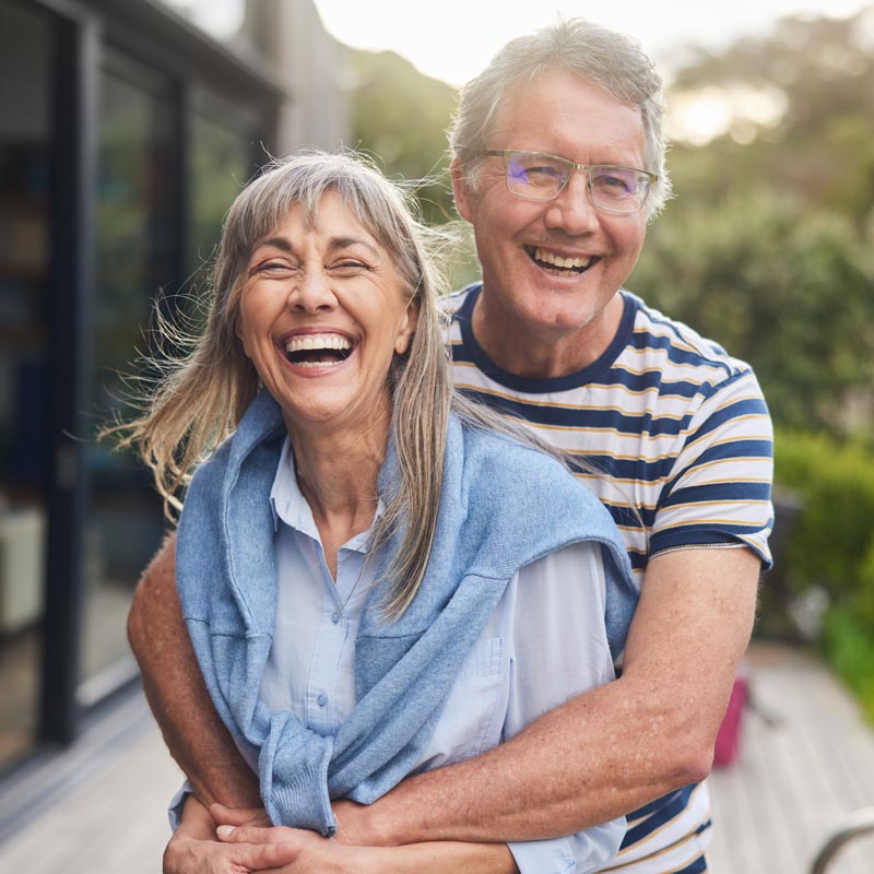 laughing and hugging senior couple
